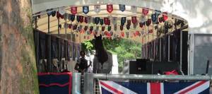 A horse and rider standing in the aisle of a temporary stable at the Olympics.